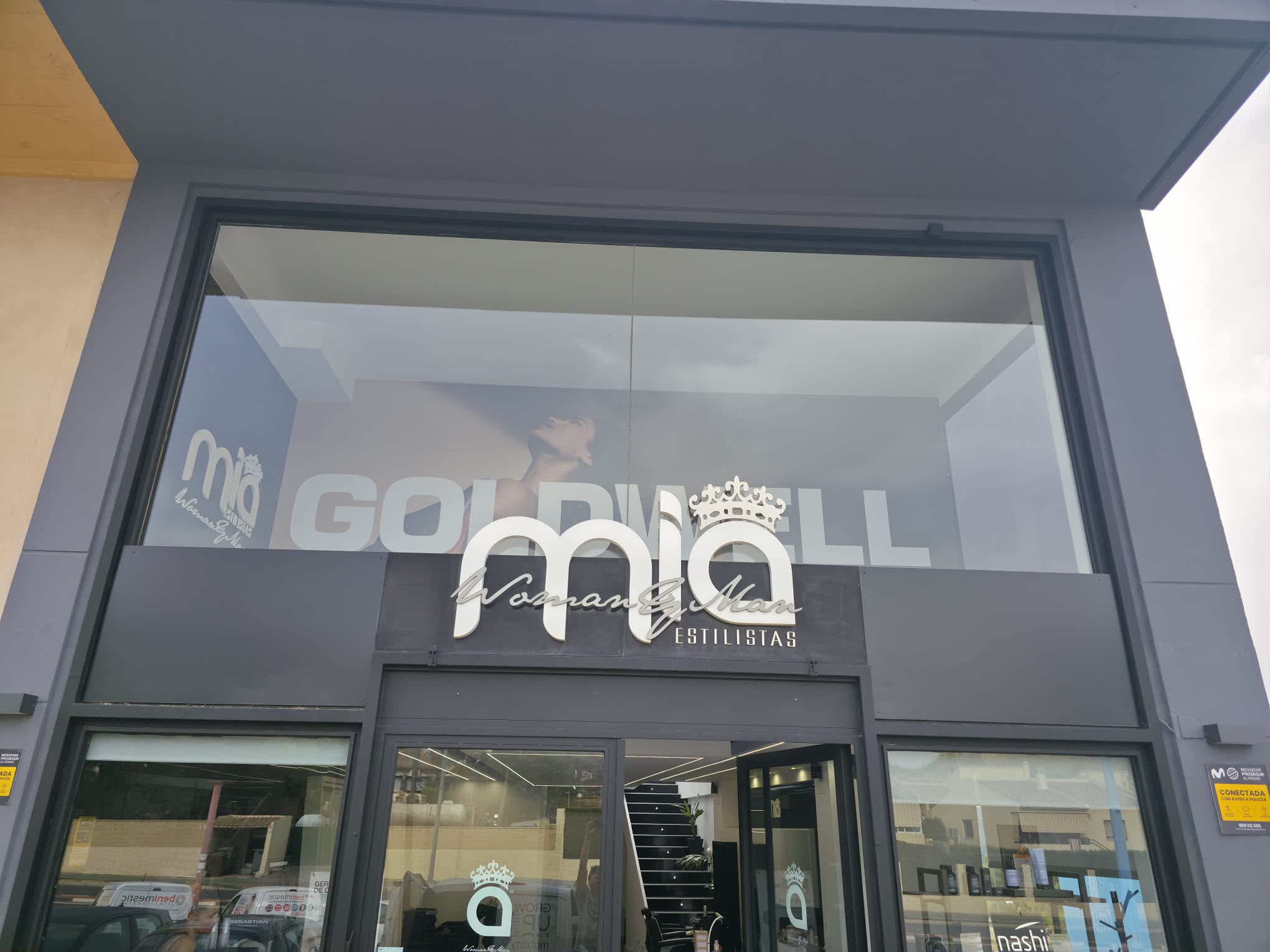Fachada del local Mia Estilistas con gráfica GOLDWELL visible en el interior